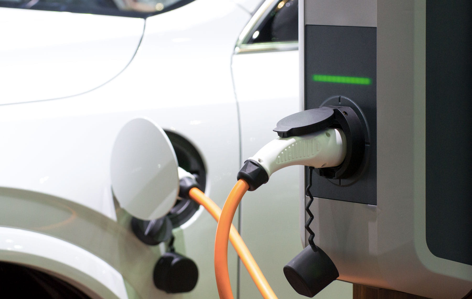 Close up of electric vehicle charging at charging station
