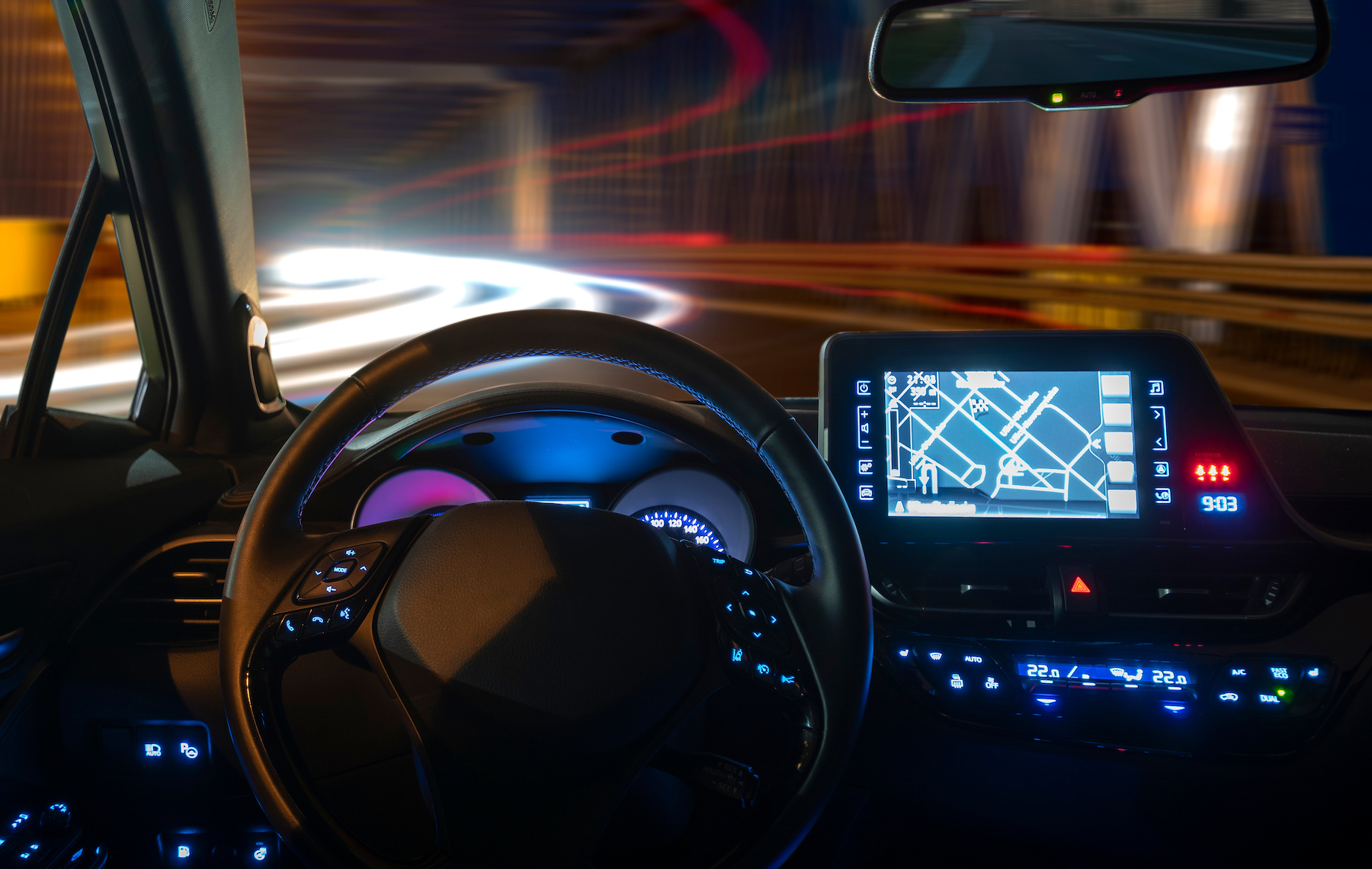Interior vehicle lighting at night with infotainment, steering wheel