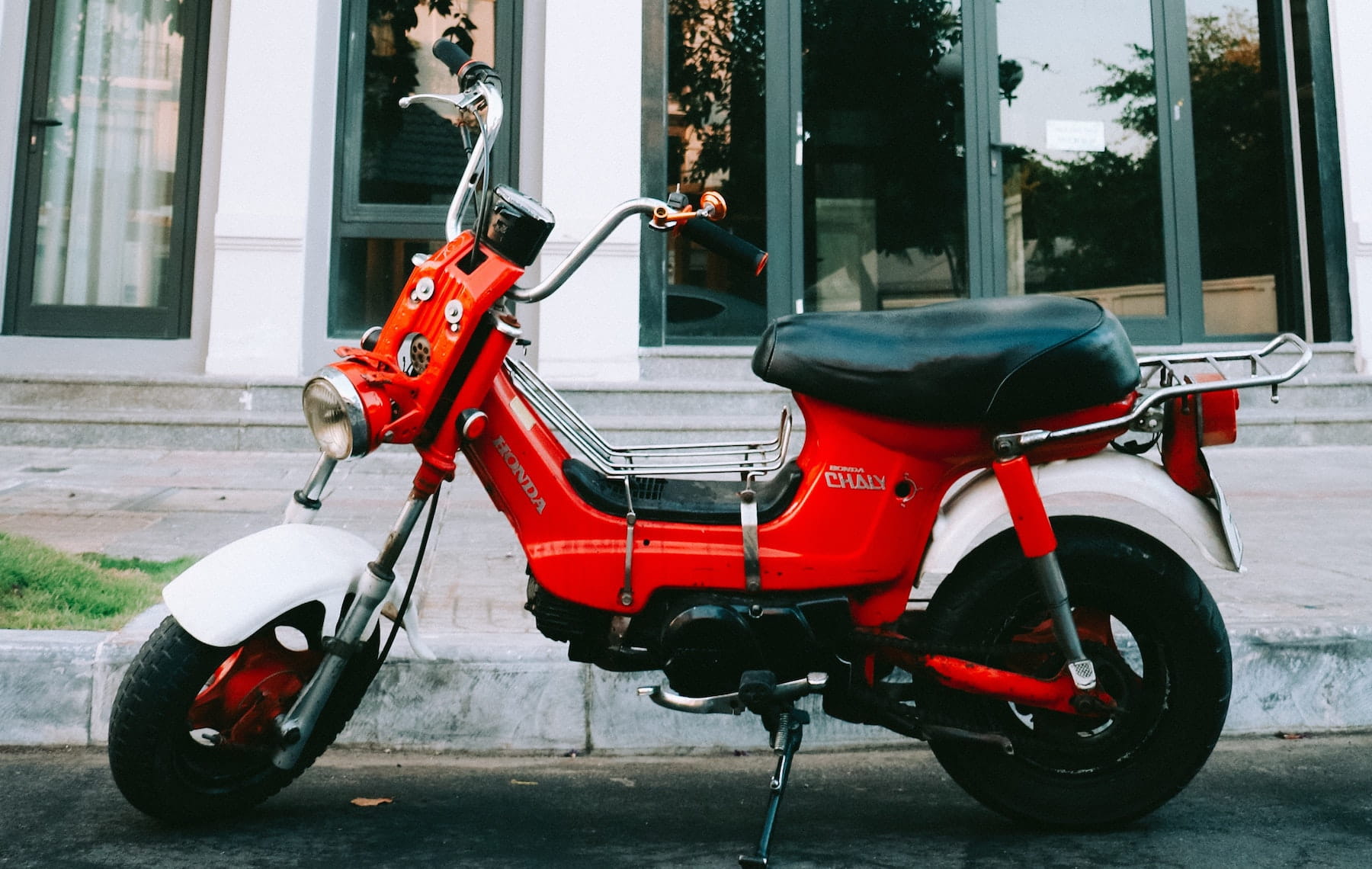 Red two-wheeler moped scooter